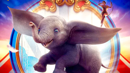 HD PC desktop wallpaper featuring Dumbo and a circus performer from the 2019 Dumbo movie, showing the flying elephant with large ears against a vibrant circus background.