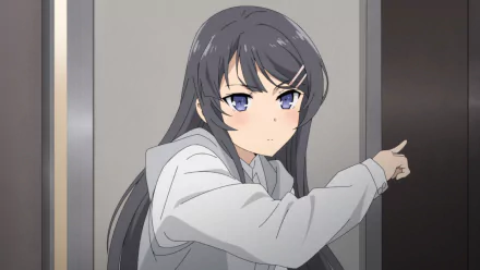 HD wallpaper featuring Mai Sakurajima from Rascal Does Not Dream of Bunny Girl Senpai, showing her with grey hair and blue eyes, pointing while standing by a door.