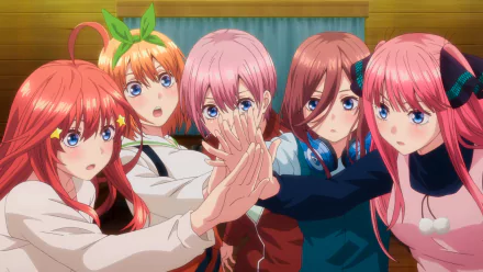 A vibrant HD desktop wallpaper featuring the Nakano quintuplets—Yotsuba, Nino, Miku, Itsuki, and Ichika—from the anime The Quintessential Quintuplets (Gotoubun no Hanayome), standing together with hands joined.