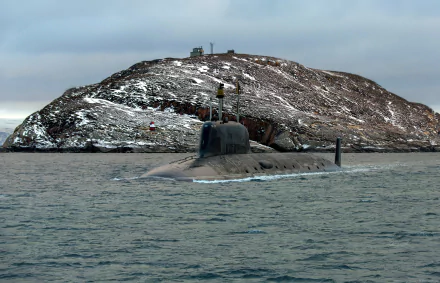 4K Ultra HD desktop wallpaper featuring a military submarine partially submerged near a rocky, snow-dusted island under a cloudy sky.