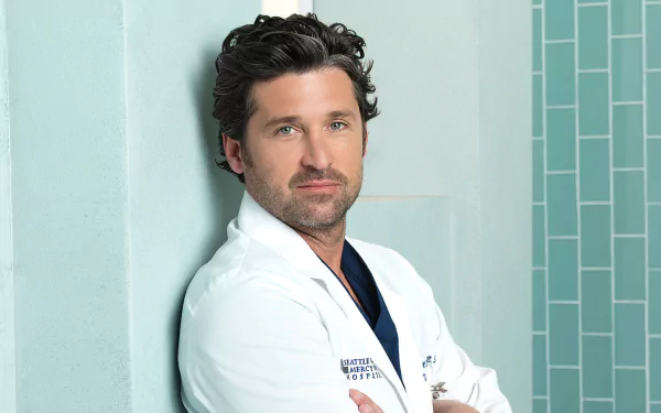 HD wallpaper featuring a character from Grey's Anatomy in a white lab coat posing confidently against a blue-tiled background.