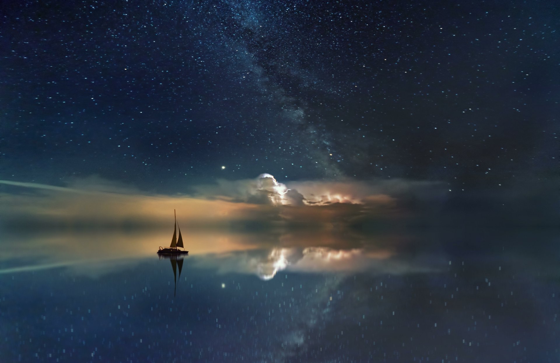 A fantasy-themed 4K Ultra HD desktop wallpaper of a lone sailboat floating on a calm ocean beneath a star-filled night sky with glowing clouds reflected in the water.