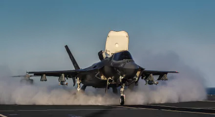 2K Quad HD desktop wallpaper: Lockheed Martin F-35 Lightning II jet fighter — US Air Force, Marine Corps and Navy warplane launching from a carrier deck.