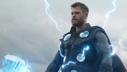 HD desktop wallpaper of Chris Hemsworth as Thor, bearded and in armor, surrounded by lightning from the Avengers: Endgame movie.