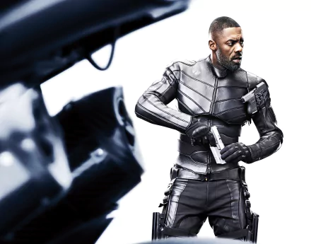 Idris Elba as Brixton Lore from Fast & Furious Presents: Hobbs & Shaw in a sleek tactical suit, holding a gun against a white background, 4K Ultra HD wallpaper.