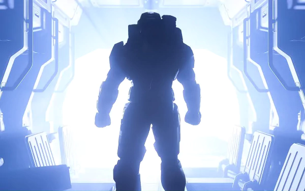 HD PC desktop wallpaper featuring Master Chief from the video game Halo Infinite, standing silhouetted in a futuristic, glowing corridor.