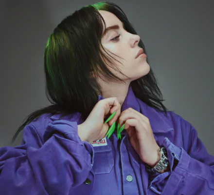 Close-up 4K Ultra HD desktop wallpaper of Billie Eilish, the American singer, wearing a purple jacket with bright green nails against a gray background.