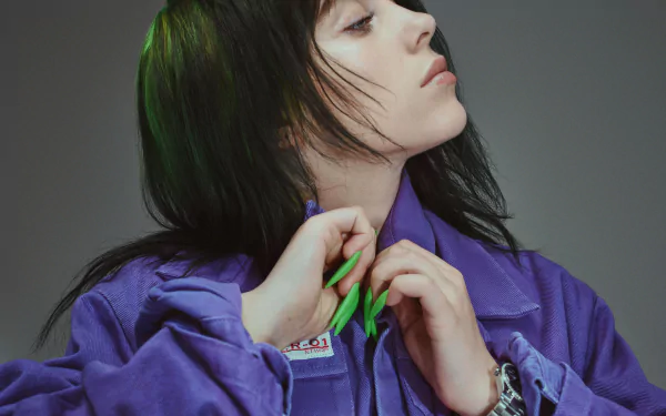 Close-up 4K Ultra HD desktop wallpaper of Billie Eilish, the American singer, wearing a purple jacket with bright green nails against a gray background.