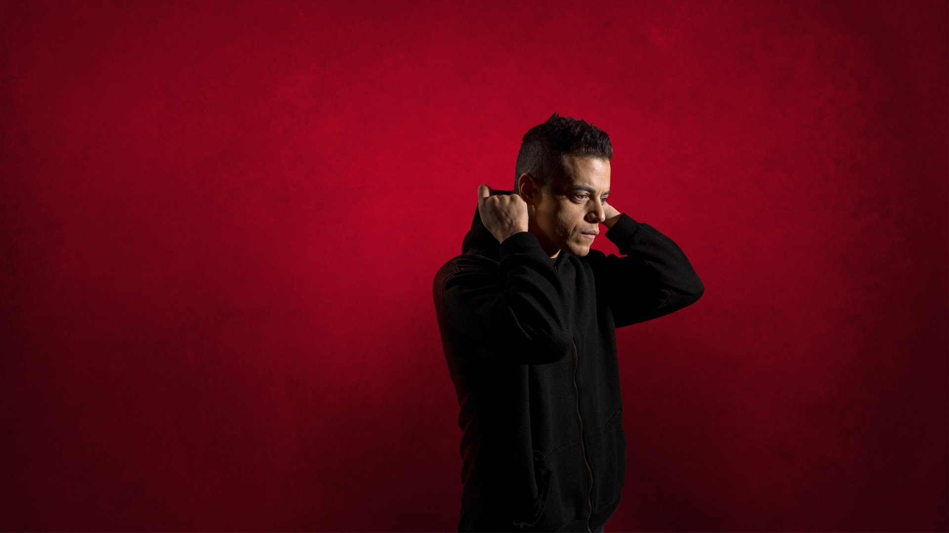 Rami Malek as Mr. Robot in a striking 8K Ultra HD PC desktop wallpaper with a bold red background.