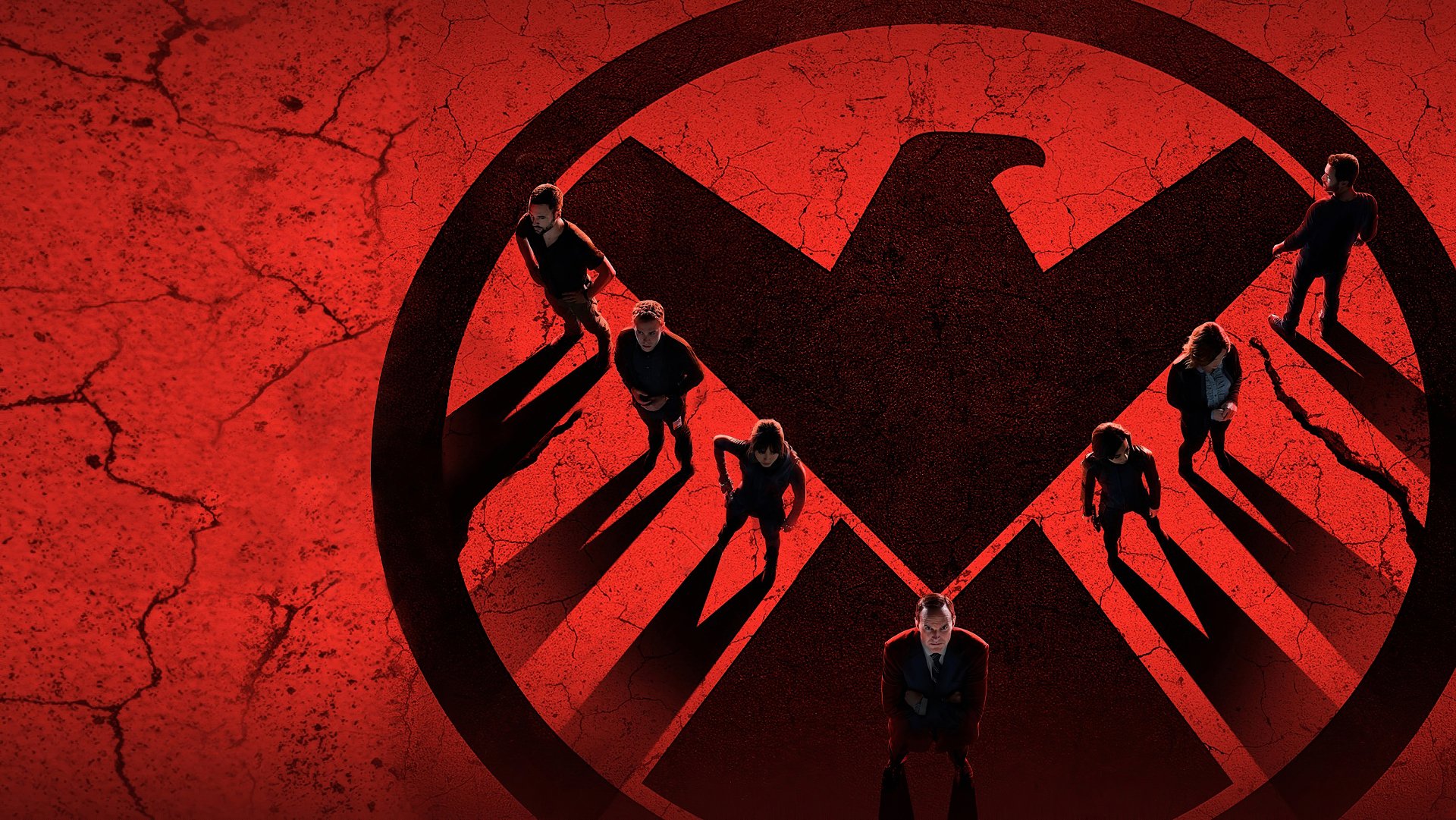 4K Ultra HD desktop wallpaper featuring the Agents of S.H.I.E.L.D. team standing on a cracked red surface with the S.H.I.E.L.D. emblem casting long shadows.