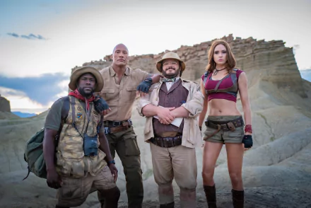 5K Ultra HD wallpaper for Jumanji: The Next Level — four costumed leads in rugged explorer gear, including a bearded adventurer and a woman in shorts, standing on rocky desert terrain.