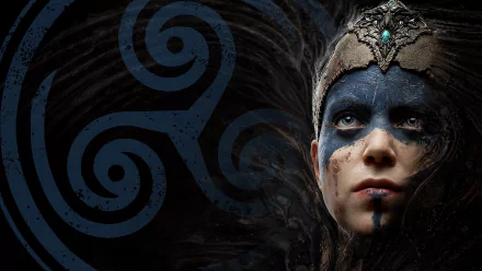 HD PC desktop wallpaper of Senua from the video game Hellblade: Senua's Sacrifice — close-up of her painted face and ornate headpiece against dark blue Celtic spirals.
