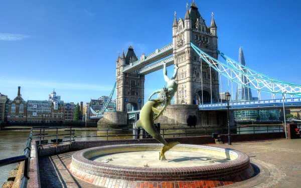 2K Quad HD desktop wallpaper of Tower Bridge, London, England, with the Thames and a leaping-dolphin fountain in the foreground.