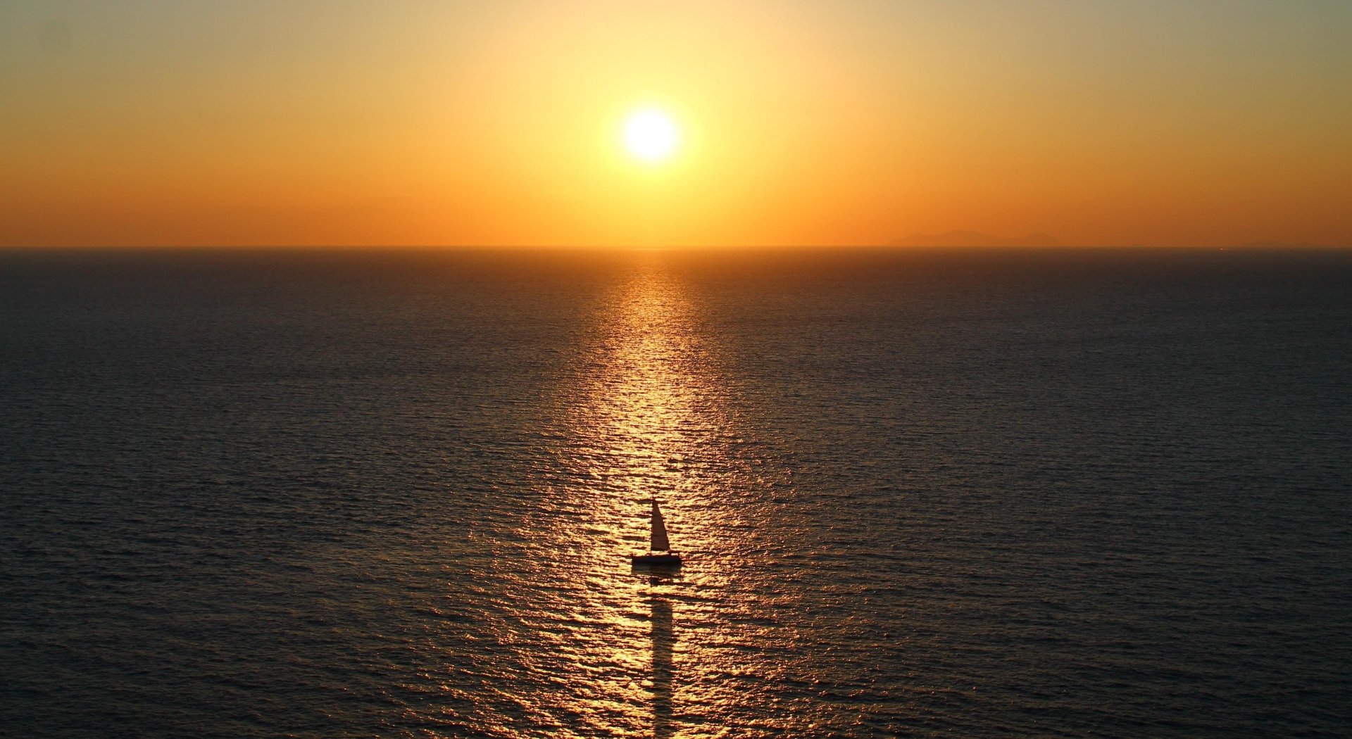 4K Ultra HD desktop wallpaper of a sailboat (ship/vehicle) heading toward the sun on the horizon, its sail and shadow reflected across the golden sea.