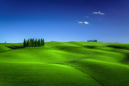 HD PC desktop wallpaper and background: rolling green Tuscan hills beneath a deep blue sky, dotted with slender cypress trees — landscape photography capturing serene countryside.