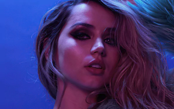 HD PC desktop wallpaper featuring a close-up of Cuban actress Ana de Armas with dramatic lighting highlighting her face against a blue background.