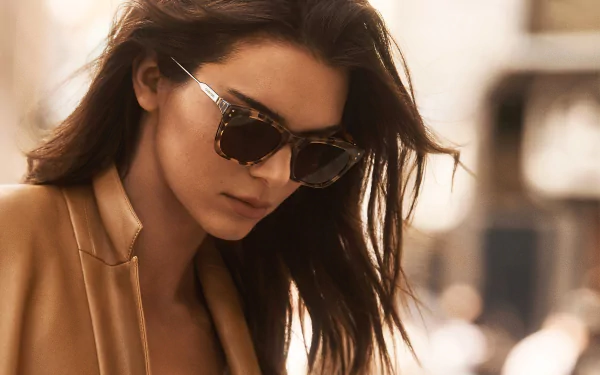 Brunette American model in tortoiseshell sunglasses, shallow depth-of-field close-up with warm cinematic lighting — HD desktop wallpaper