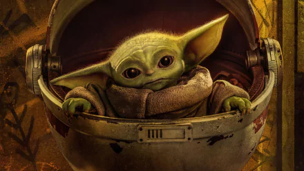 HD desktop wallpaper featuring Grogu, also known as Baby Yoda, from the TV show The Mandalorian. Grogu is depicted in a cozy pod against a detailed background, embodying the charm of the Star Wars universe.