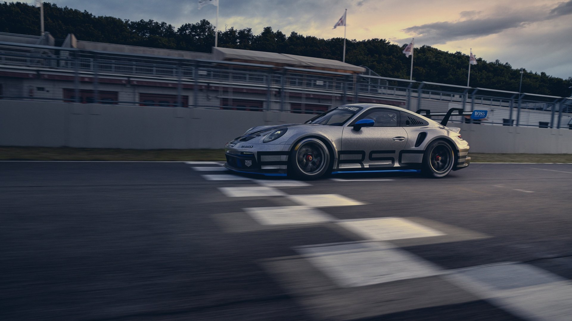 Silver Porsche 911 GT3 on a racetrack crossing the start/finish line — high-detail 4K Ultra HD PC desktop wallpaper background.