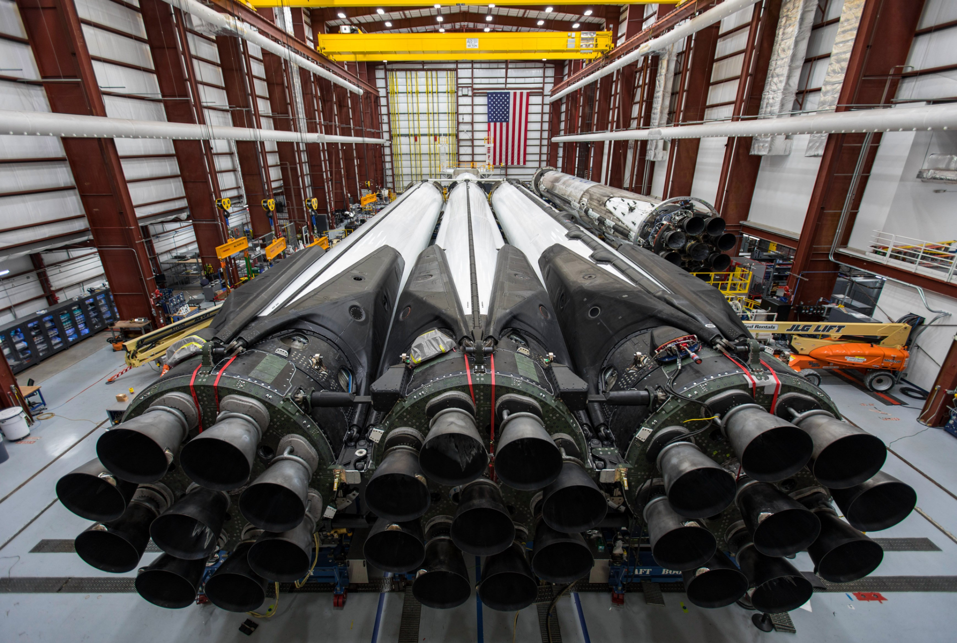 HD wallpaper of SpaceX's Falcon Heavy rocket in the hangar, showcasing its impressive array of engines.