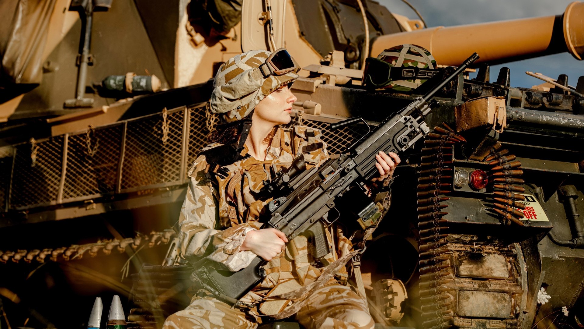 A soldier in full military gear holds a weapon while sitting beside an armored vehicle, captured in sharp detail for a 4K Ultra HD army-themed desktop wallpaper.