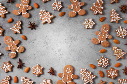 Gingerbread cookies and almonds form a border on a gray textured surface — festive food cookie scene rendered as a 5K Ultra HD PC desktop wallpaper and background.