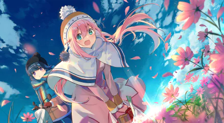 HD wallpaper of Laid-Back Camp: cheerful pink-haired Nadeshiko Kagamihara in a winter coat with long hair and flowers around her, Rin Shima bundled up in the background beneath a bright blue sky.