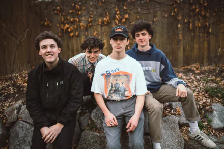 HD desktop wallpaper featuring a group of four young individuals outdoors, associated with Ritt Momney, against a backdrop of autumn leaves.