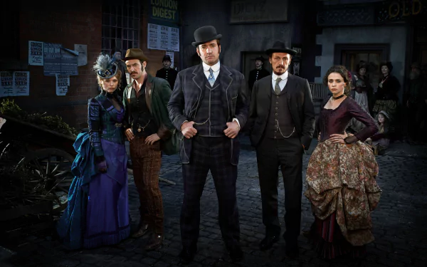 HD wallpaper featuring characters from Ripper Street standing confidently on a cobbled street, poised for drama.