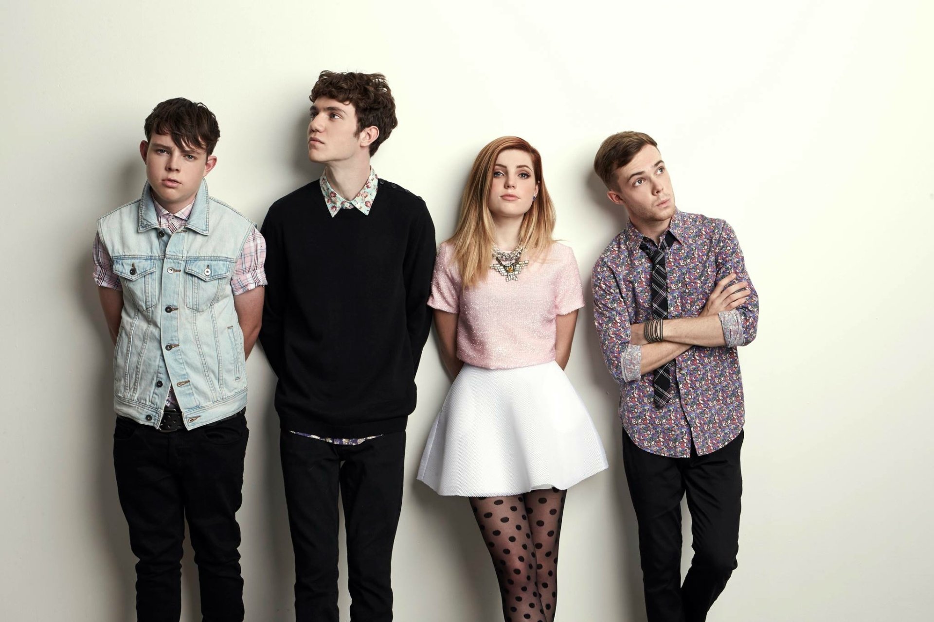 HD desktop wallpaper featuring the band Echosmith with a member in a white skater skirt, posing against a light background.