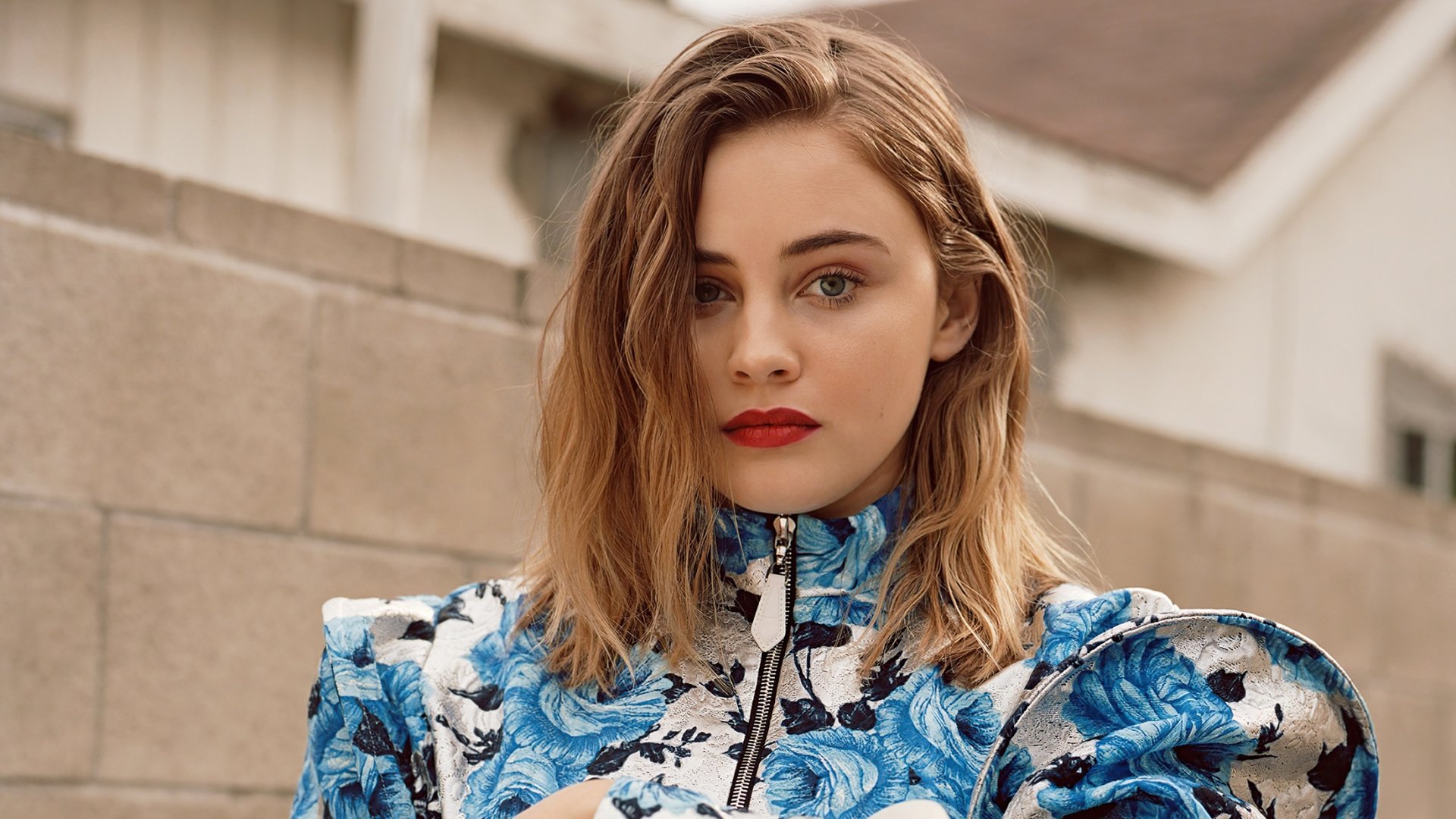 HD desktop wallpaper featuring Australian actress Josephine Langford with blonde hair and bold red lipstick, wearing a blue floral outfit.