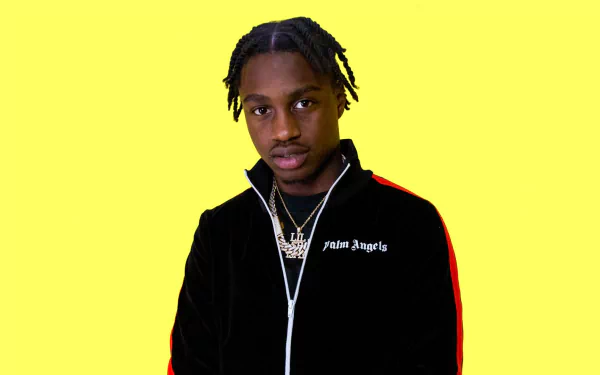 HD desktop wallpaper featuring a person with a neutral expression, wearing a black and red jacket against a yellow background.