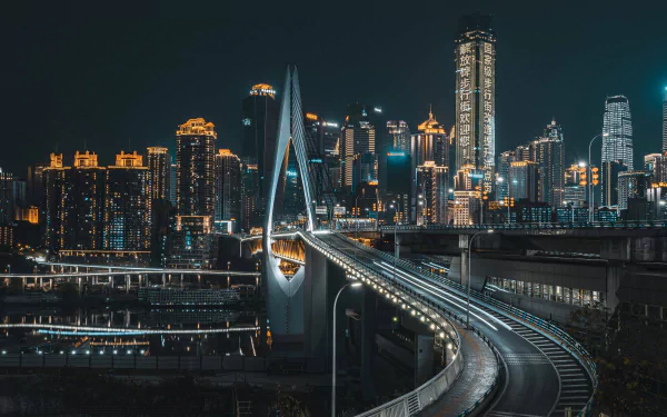 HD desktop wallpaper showing a night view of a bridge leading into the illuminated skyscrapers of Chongqing, China, highlighting the city's modern architecture.