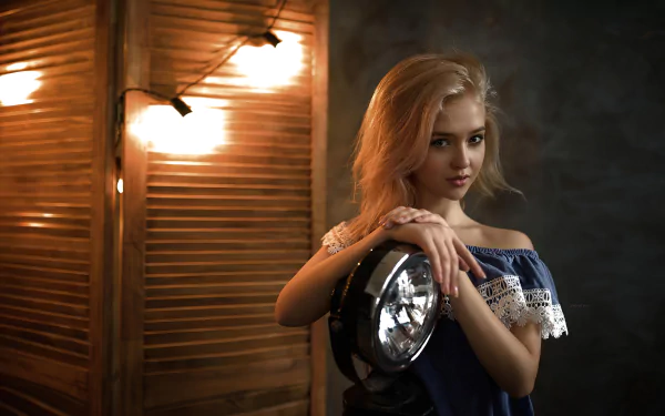 Blonde woman model in a blue dress poses indoors against warm lighting, captured in a 4K Ultra HD desktop wallpaper and background.