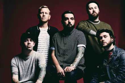 HD desktop wallpaper featuring a posed group of five band members against a red backdrop, tagged with A Day To Remember.