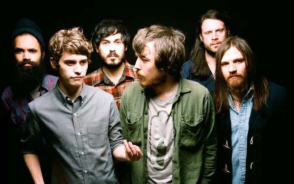 HD desktop wallpaper featuring the band Fleet Foxes, with members posed against a dark background.