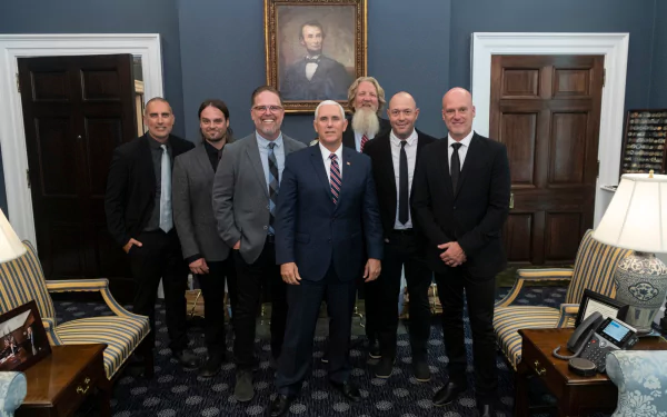 Group of men posing for a photo in an elegant room with historical decor as HD desktop wallpaper tagged with mercyme.