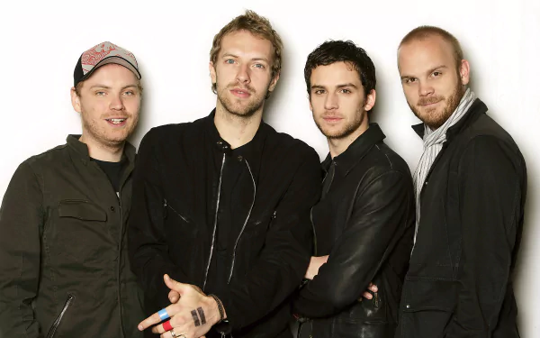 HD wallpaper featuring a group of four men posing together against a plain background, evocative of the band tagged in the image.