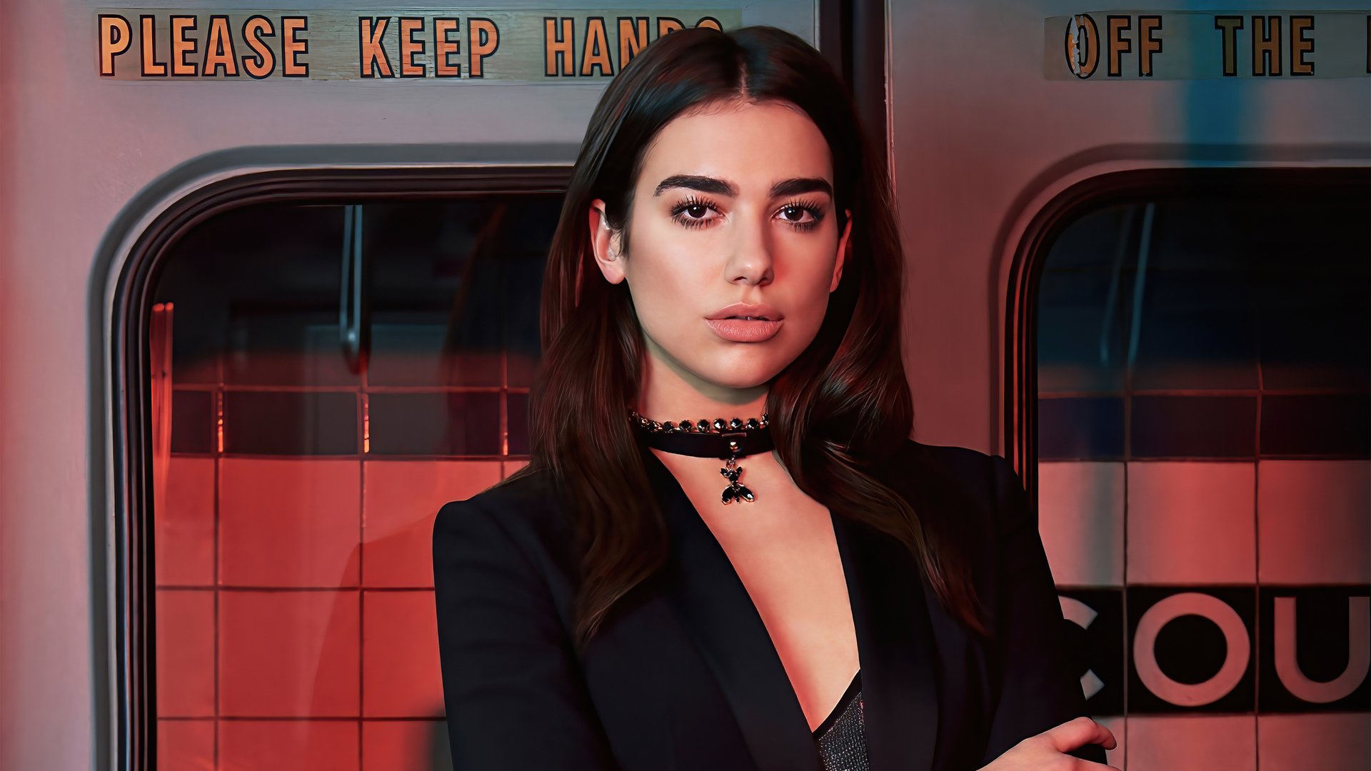 HD PC desktop wallpaper: music-themed portrait of a poised woman in a black blazer and choker standing against a moody subway-platform backdrop.