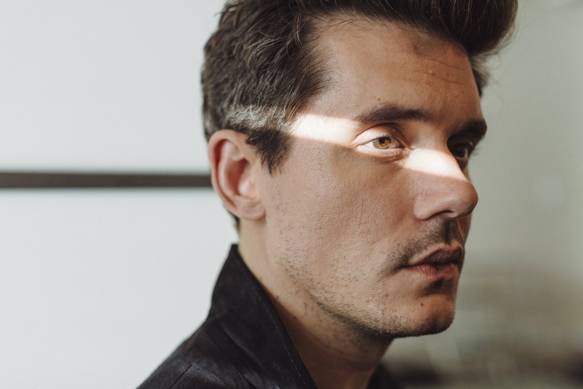 A close-up portrait of John Mayer, captured in soft light, creates a striking HD desktop wallpaper and background for music enthusiasts.