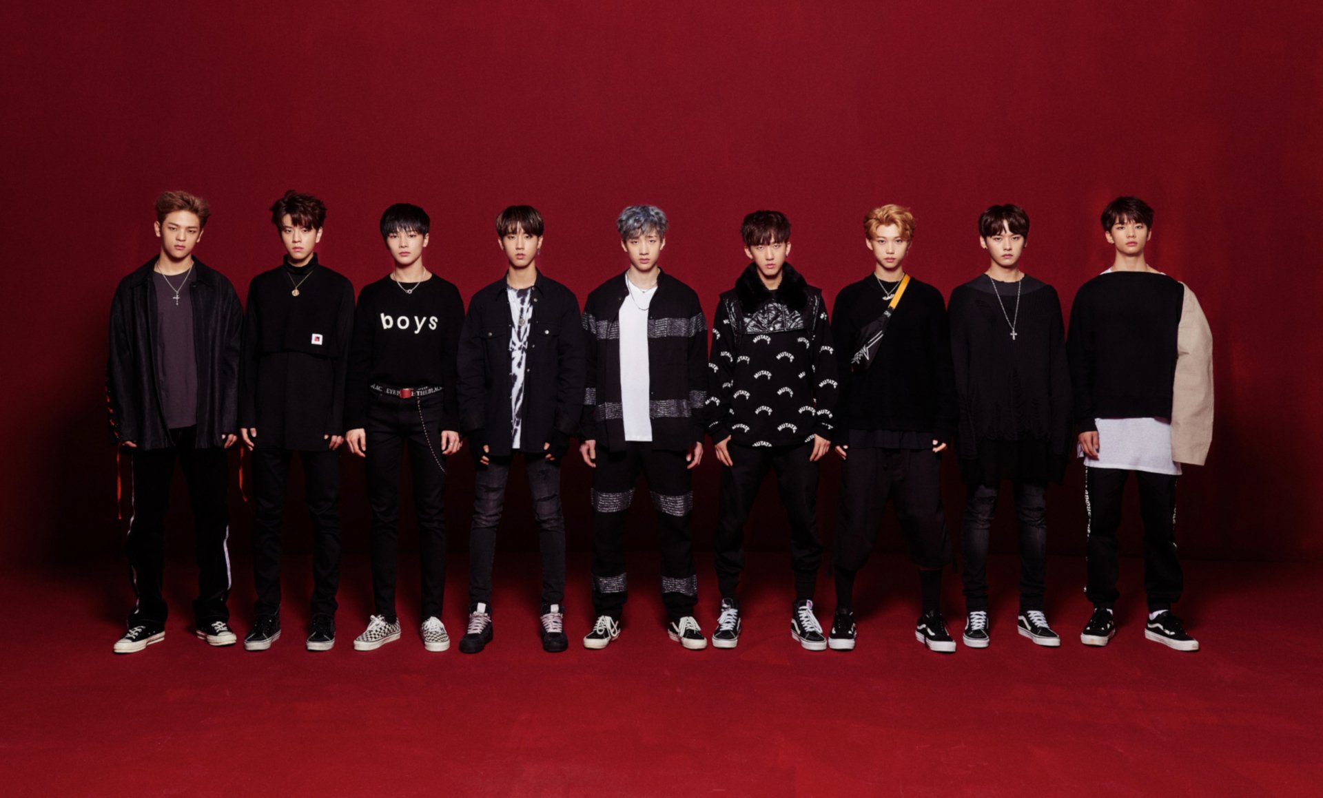 HD PC desktop wallpaper featuring the K-pop boy band Stray Kids posing against a deep red background.