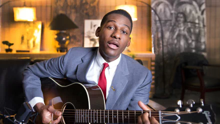 HD desktop wallpaper and background featuring a musician with a guitar, sitting in a vintage-styled room.