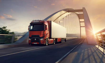 Red Renault Trucks semi crossing an arched bridge at sunrise, cinematic Euro Truck Simulator 2 video game render, 8K Ultra HD PC desktop wallpaper and background.