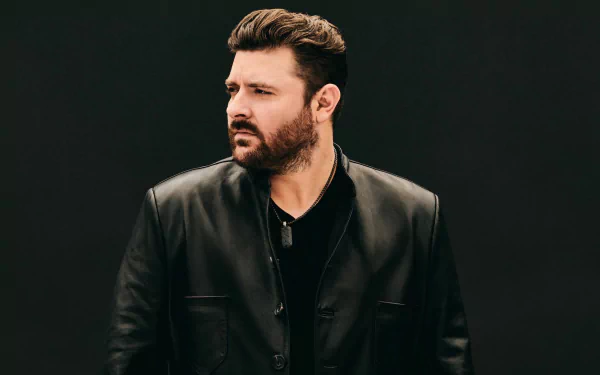 Man in black leather jacket posing for a HD desktop wallpaper.