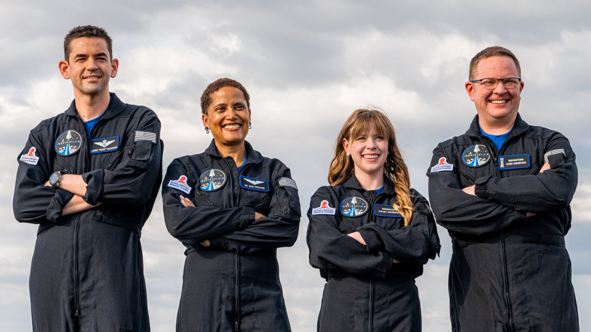 Inspiration4 crew in flight suits posing for HD desktop wallpaper.