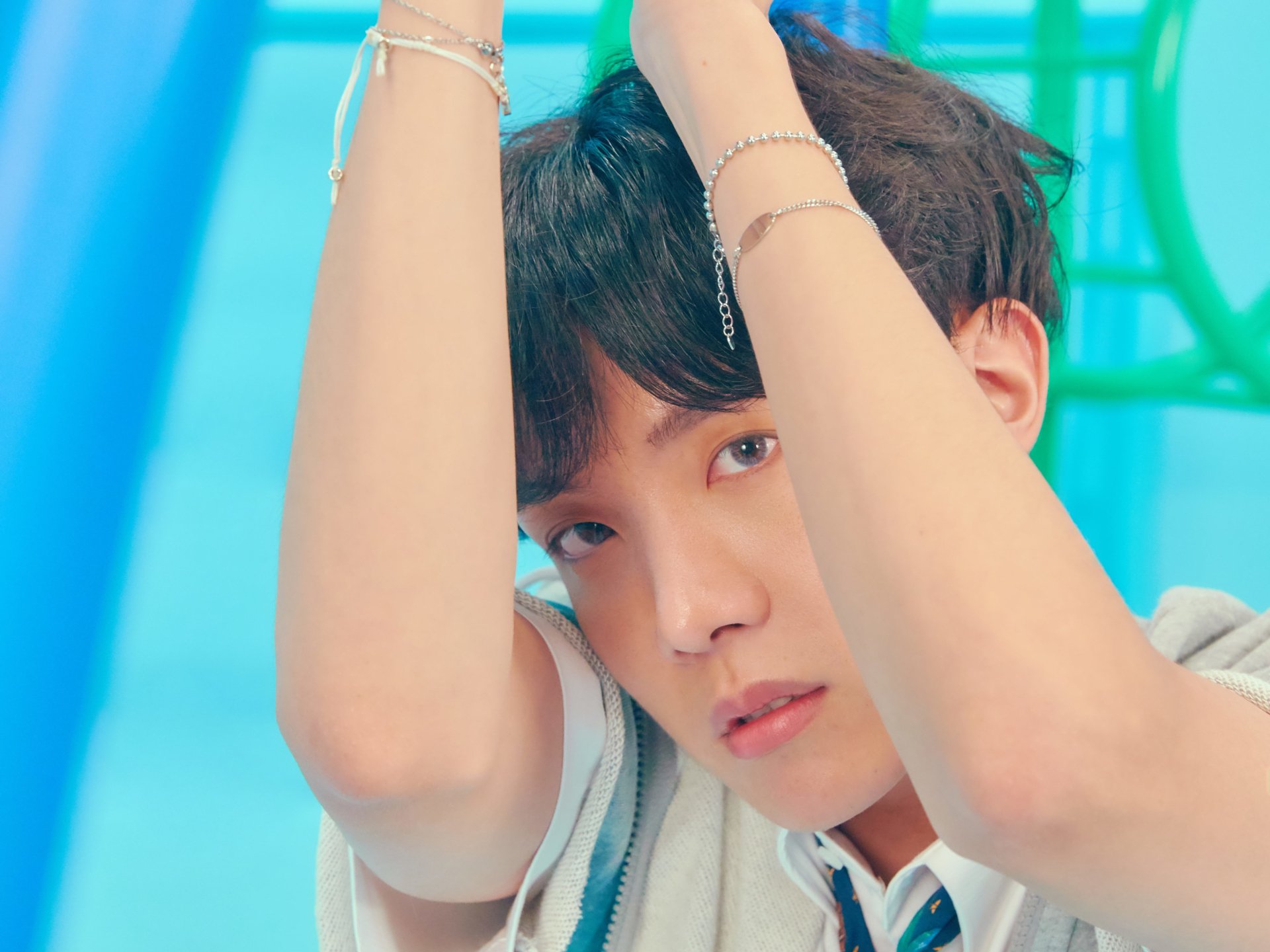 Close-up 4K Ultra HD wallpaper of J-Hope (Jung Hoseok) from BTS, showcasing the K-pop singer in a vibrant, colorful setting.