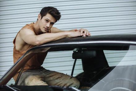 A stylish man leaning on a car door, posing for an HD desktop wallpaper and background.