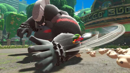 HD PC desktop wallpaper of Kirby (video game) from Kirby and The Forgotten Land: tiny Kirby spins into a fallen giant robotic gorilla amid a bright, overgrown urban park background.