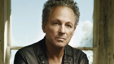 High-definition desktop wallpaper featuring a portrait of a man in a black leather jacket, with a thoughtful expression and a soft-focus background.