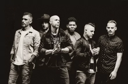 A high-definition desktop wallpaper featuring Chris Daughtry and his band, showcasing their dynamic presence and music energy against a dark background.